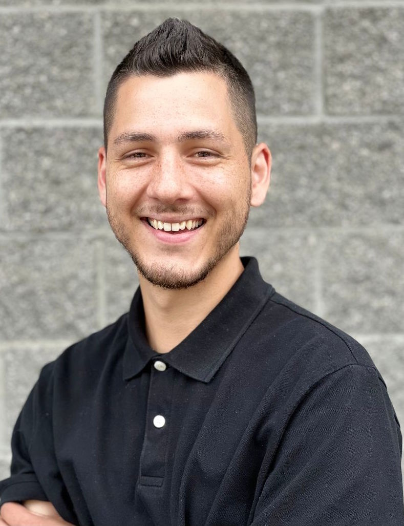 Professional Portrait of Patricio Salazar - Headshot a few feet in front of a beige brick wall